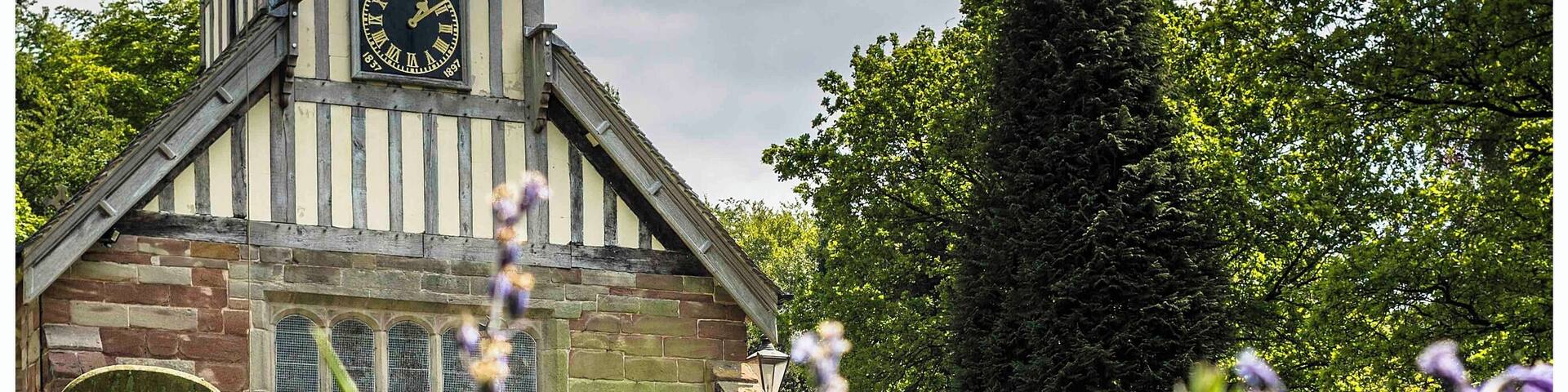The stunning Saint Mary and All Saints Church in the Vale of Whitmore set amongst the bluebells of spring.