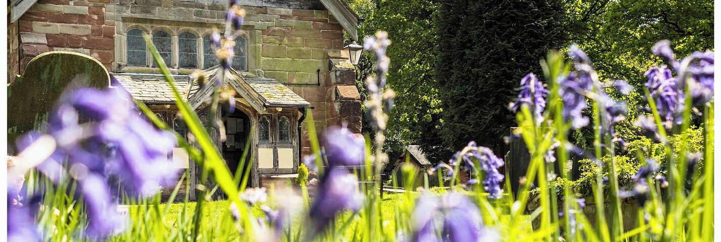 The stunning Saint Mary and All Saints Church in the Vale of Whitmore set amongst the bluebells of spring.