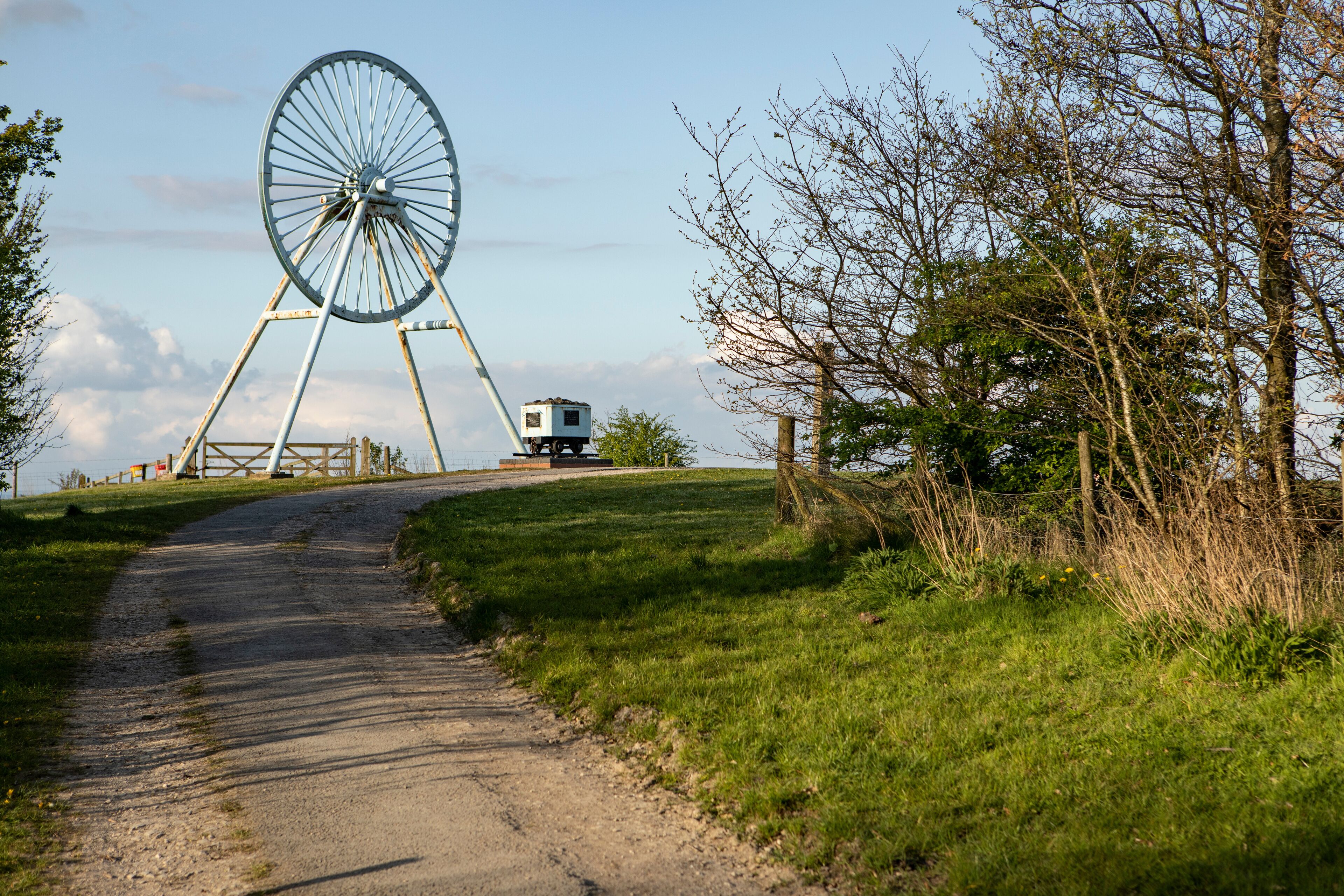 Newcastle-under-Lyme, Staffordshire, uk, 04,25.2022,Apedale pit wheel memorial and coal tub located in Apedale community park, formerly opencast mining