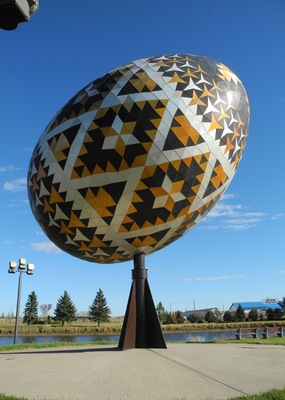 The Vegreville egg is a giant sculpture of a pysanka, a Ukrainian-style Easter egg. The work by Paul Maxum Sembaliuk is built of an intricate set of two-dimensional anodized aluminum tiles in the shape of congruent equilateral triangles and star-shaped hexagons, fashioned over an aluminum framework. The egg is 31 ft (9 m) long and three and a half stories high, weighing in at 2.5 t (5,512 lb). It is the second largest pysanka in the world. The biggest one was built in Kolomyia, Ukraine in 2000.
The sculpture was commissioned by the town of Vegreville, in the Canadian province of Alberta noted for its high Ukrainian Canadian population. In order to obtain funding for it, the town applied for a federal government grant and was eventually able to obtain some funding, but only if the sculpture was dedicated to the 1975 centennial of the Royal Canadian Mounted Police. Vegreville received a grant to construct the egg, a nod at Ukrainian culture in Canada, and specifically at early Ukrainian settlements east of Edmonton, Alberta.
#LikeALocal #TroveOnTuesday #Culture Photo Contest