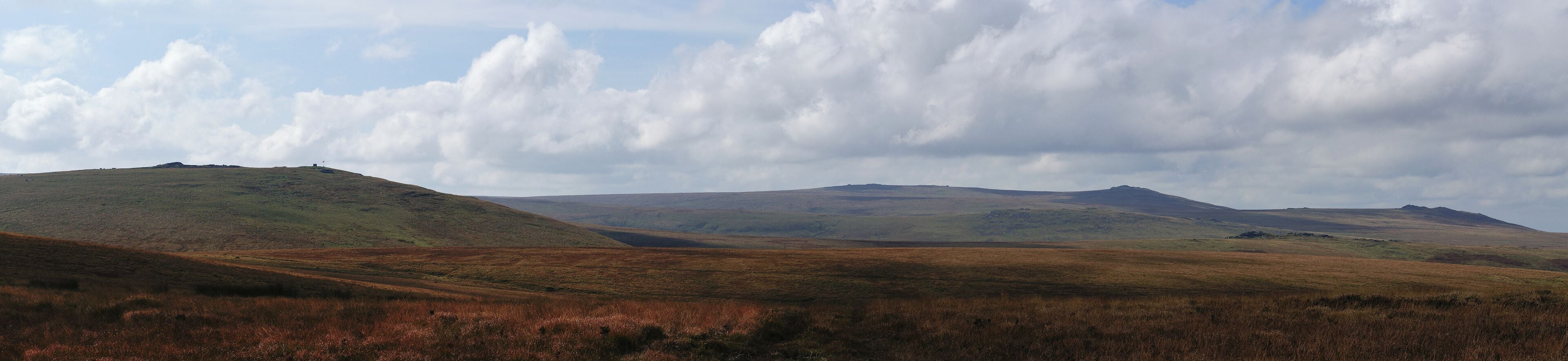 Panorama of northern Dartmoor, Devon, UK showing some of the major tors (including the highest on the moor) in that area. A large part of what can be seen is in a military firing area and an observation hut and warning flag can be seen.