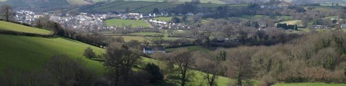 Landscape at Waddon. A view over the valley shown in the similar 750758, trees following the small stream that drains into the Kate Brook. The farmhouse in the centre is at 139336. Beyond is the northern part of Chudleigh, in SX8779 and SX8679, with Hennock on the distant hillside. The wooded ravine on the extreme right is 174161.