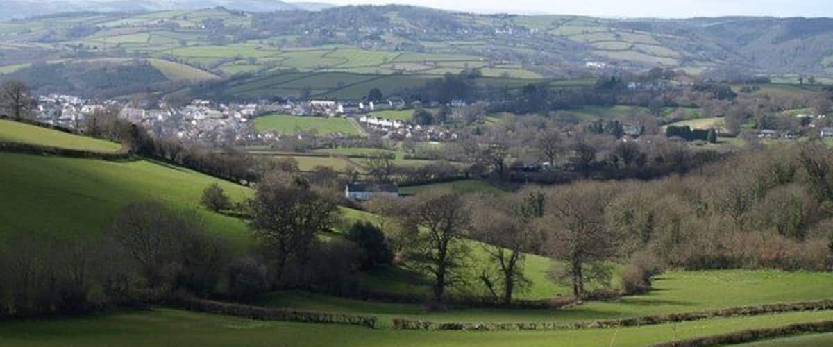 Landscape at Waddon. A view over the valley shown in the similar 750758, trees following the small stream that drains into the Kate Brook. The farmhouse in the centre is at 139336. Beyond is the northern part of Chudleigh, in SX8779 and SX8679, with Hennock on the distant hillside. The wooded ravine on the extreme right is 174161.