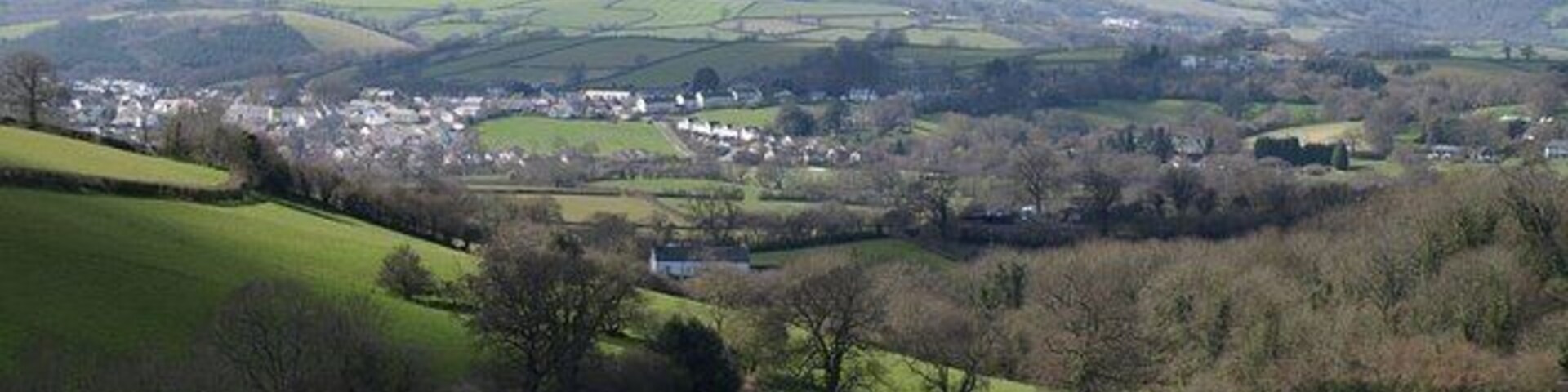 Landscape at Waddon. A view over the valley shown in the similar 750758, trees following the small stream that drains into the Kate Brook. The farmhouse in the centre is at 139336. Beyond is the northern part of Chudleigh, in SX8779 and SX8679, with Hennock on the distant hillside. The wooded ravine on the extreme right is 174161.