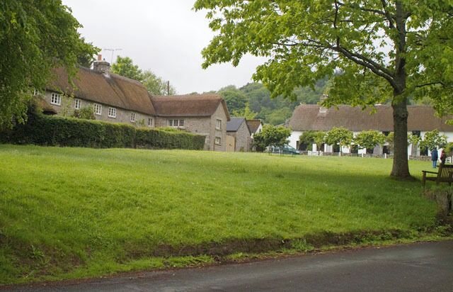 Village Green, Manaton. This is a view across the village green to the traditional thatched cottages surrounding the green.
