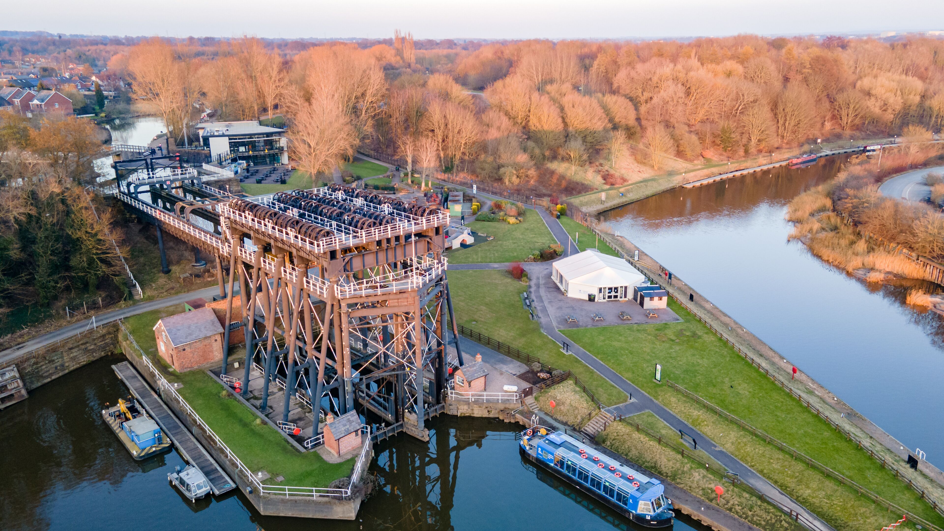 A river with a bridge, a lock system, and a boat dock.