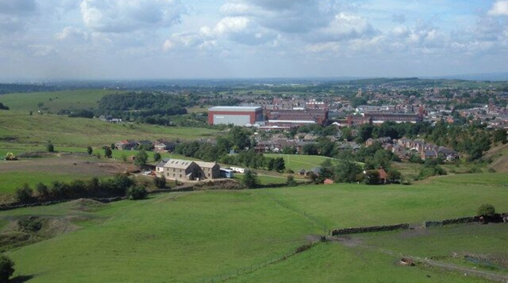 A view of Shaw and Crompton, Oldham, Greater Manchester, England. Looking west into square grid reference SD9408 from grid reference SD951088 towards Shaw's remaining cotton mills now in use as storage and distribution centres.