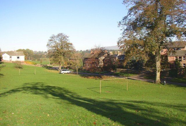 Football ground on the village green, Temple Sowerby Sometimes the ball must go careering off down the road!