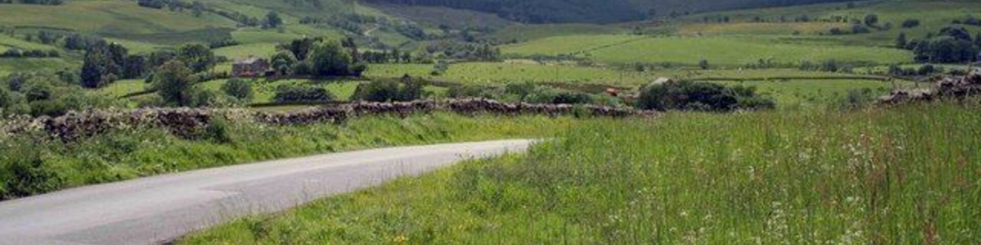 the road to Greenholme After a shower its very clear today looking down the valley towards Greenholme.