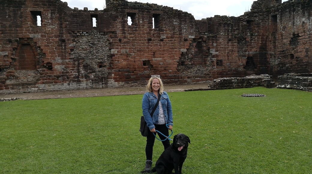 Red ruins of a Castle in the market town of Penrith. There's also a park with bandstand & cafe.