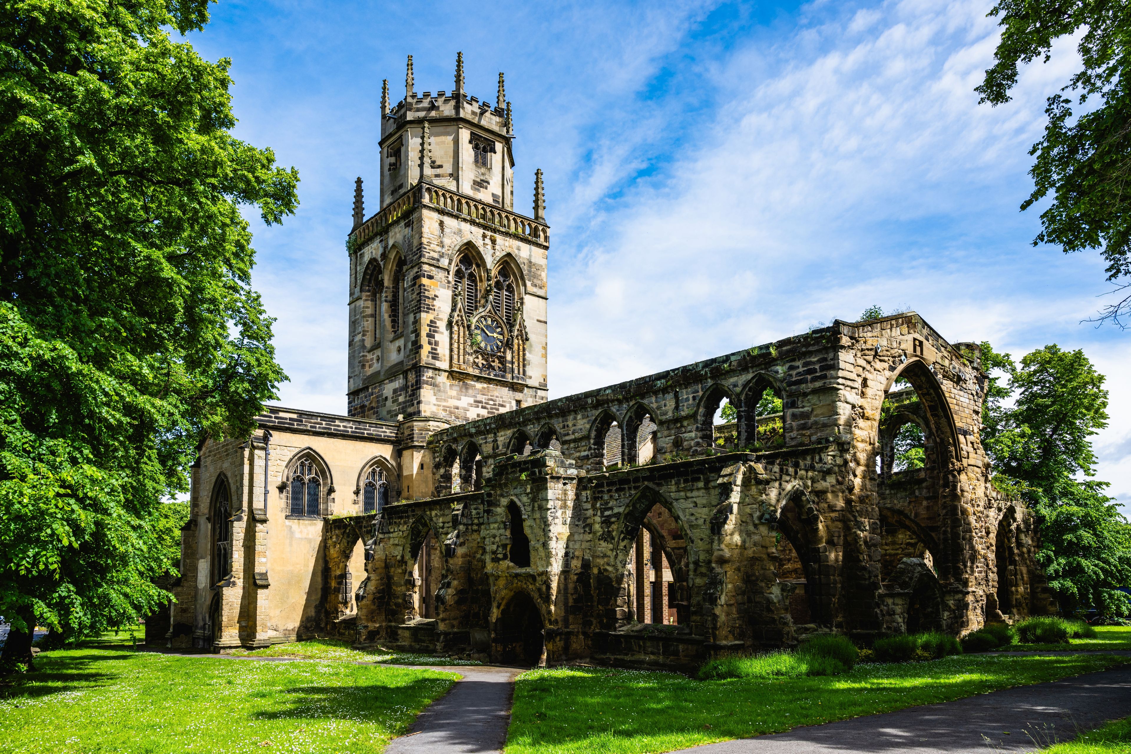 A historic church with a tall tower and arched windows.