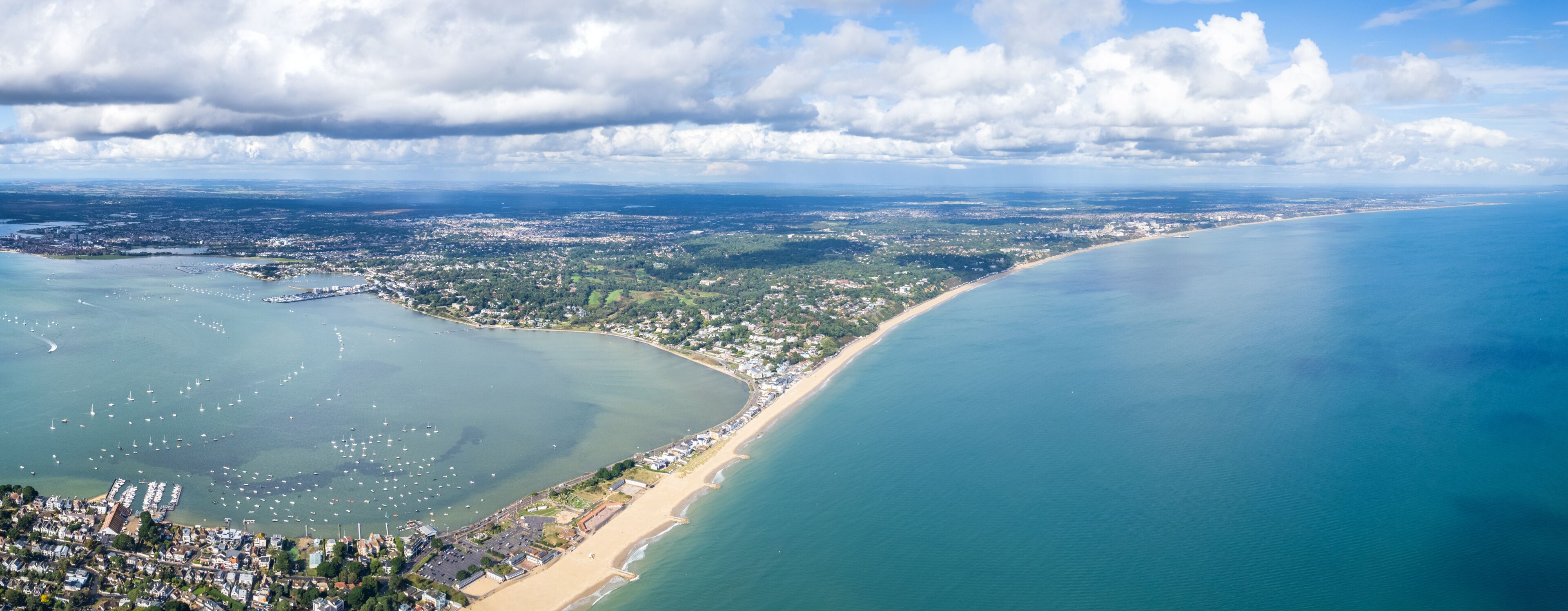 A coastal city with a bay, marina, and beach.