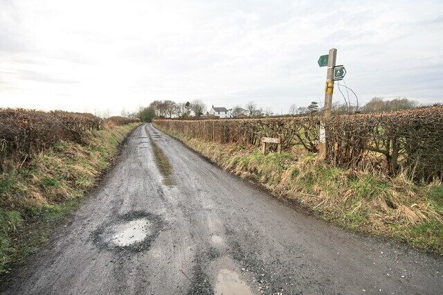 Farm Road off Wheel Lane Leads to Bibbys and Simpsons Farms - the wooden sign simply says "Bimpson". Carries a public footpath.