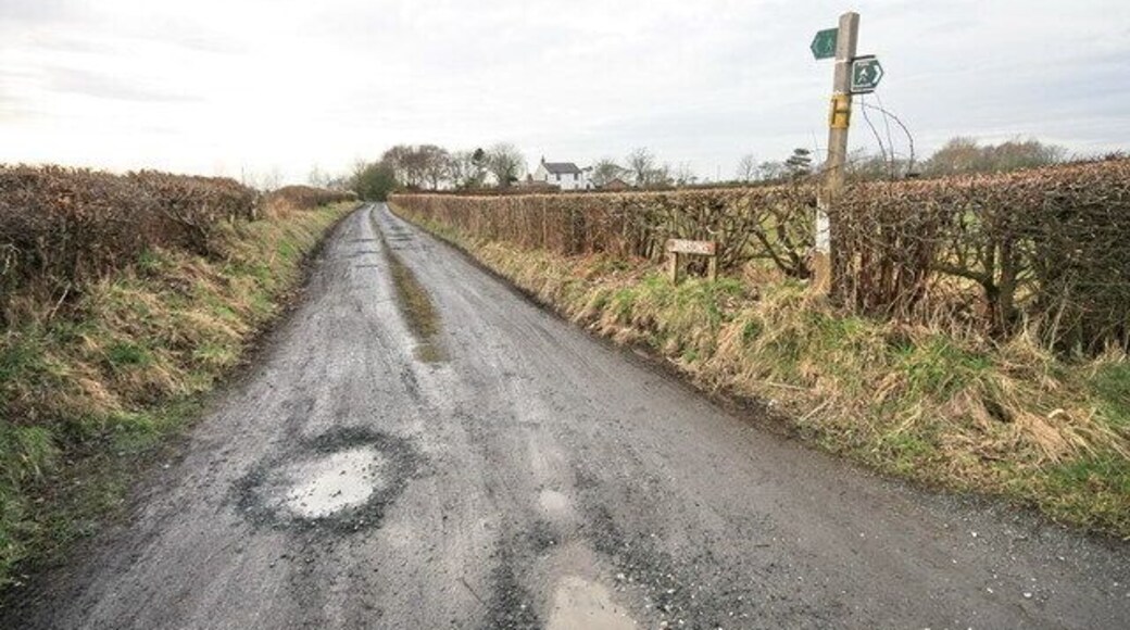 Farm Road off Wheel Lane Leads to Bibbys and Simpsons Farms - the wooden sign simply says "Bimpson". Carries a public footpath.