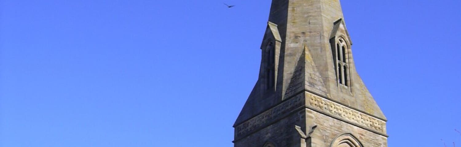 Spire and upper stages of the south tower of St Nicholas' parish church, Wrea Green, Lancashire, seen from the southwest
