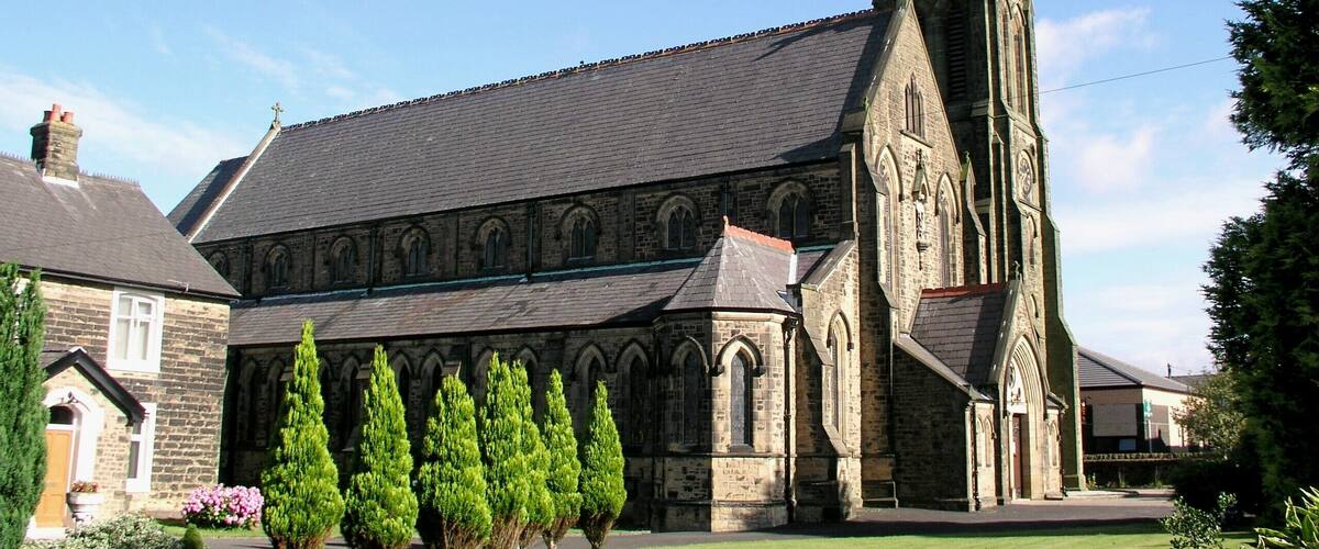 A church with a tall spire and a stone facade.