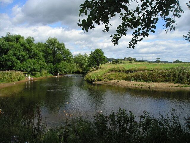 River Wyre from Garstang Car Park. View of the River Wyre on a summer's day. Greenhalgh Castle is in the distance.
