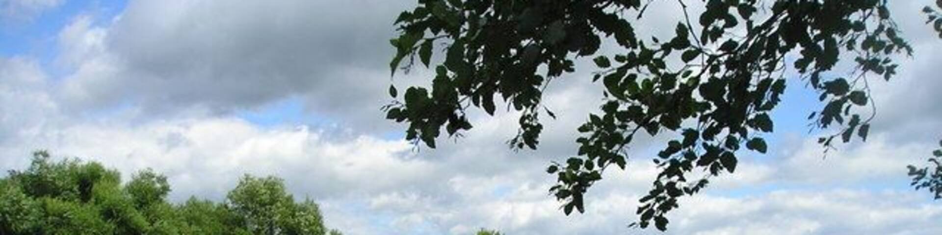 River Wyre from Garstang Car Park. View of the River Wyre on a summer's day. Greenhalgh Castle is in the distance.