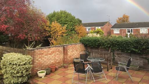 Rainbows on a grey sky from my garden beautiful against the autumn colours