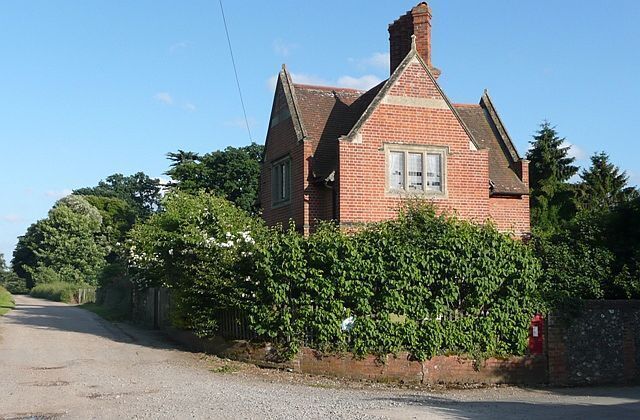 The Lodge, Mapledurham, Oxfordshire. Its chimneys and gables emulate those of the house. The track to the left is the bridleway via Park Farm to The Warren in Reading.