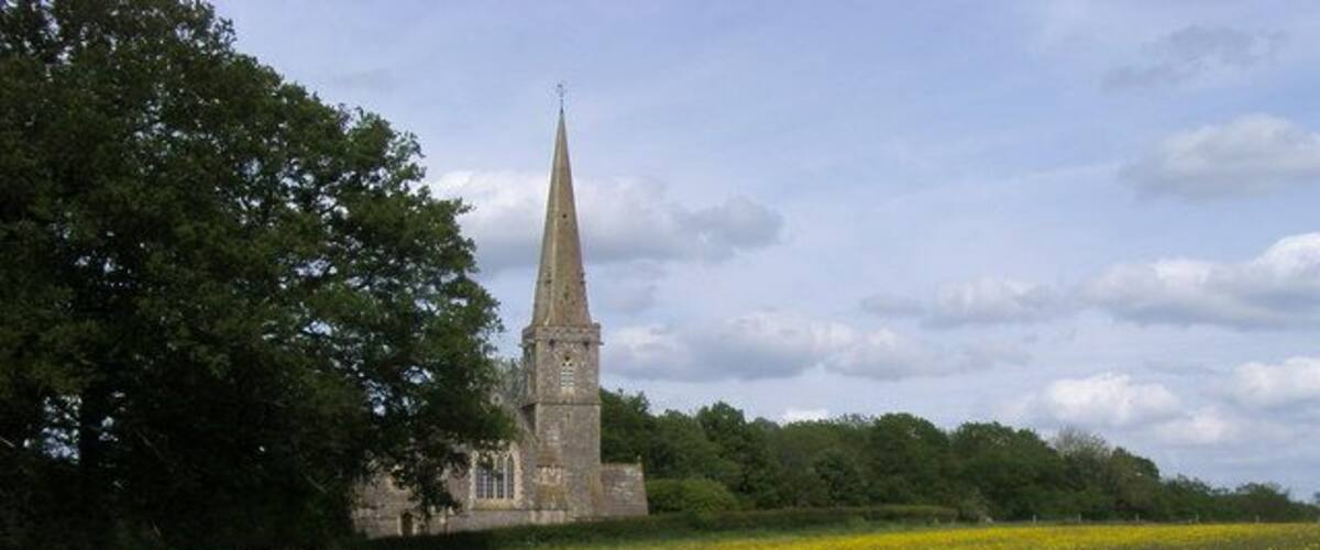 View northeast across a field at Midgham, Berkshire to St Matthew's parish church