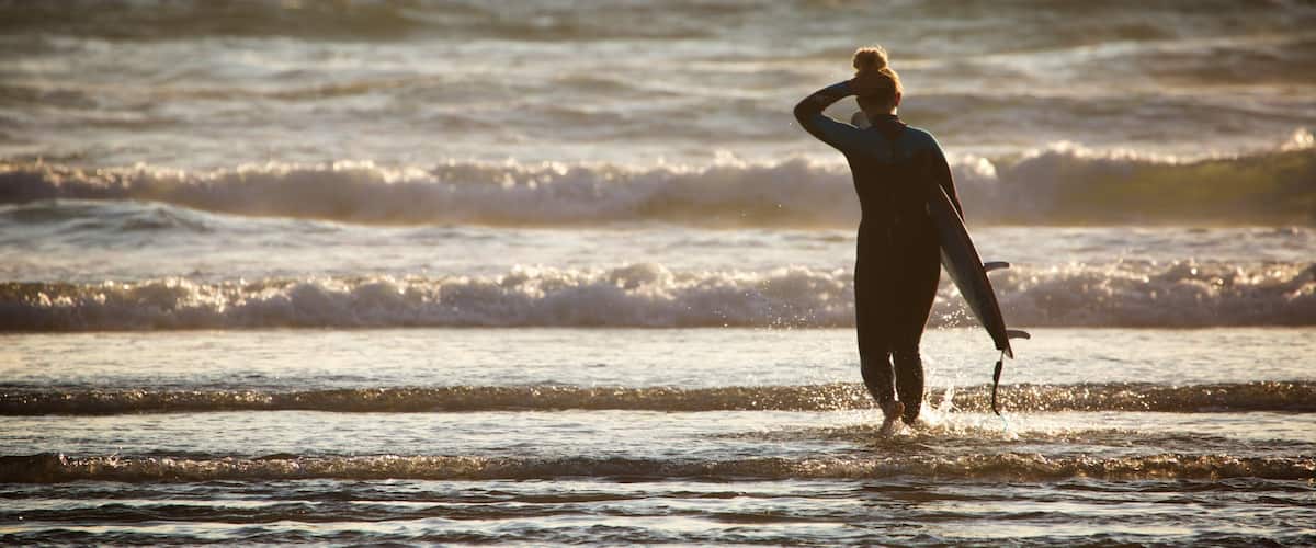 Woolacombe showing waves and surfing as well as an individual femail
