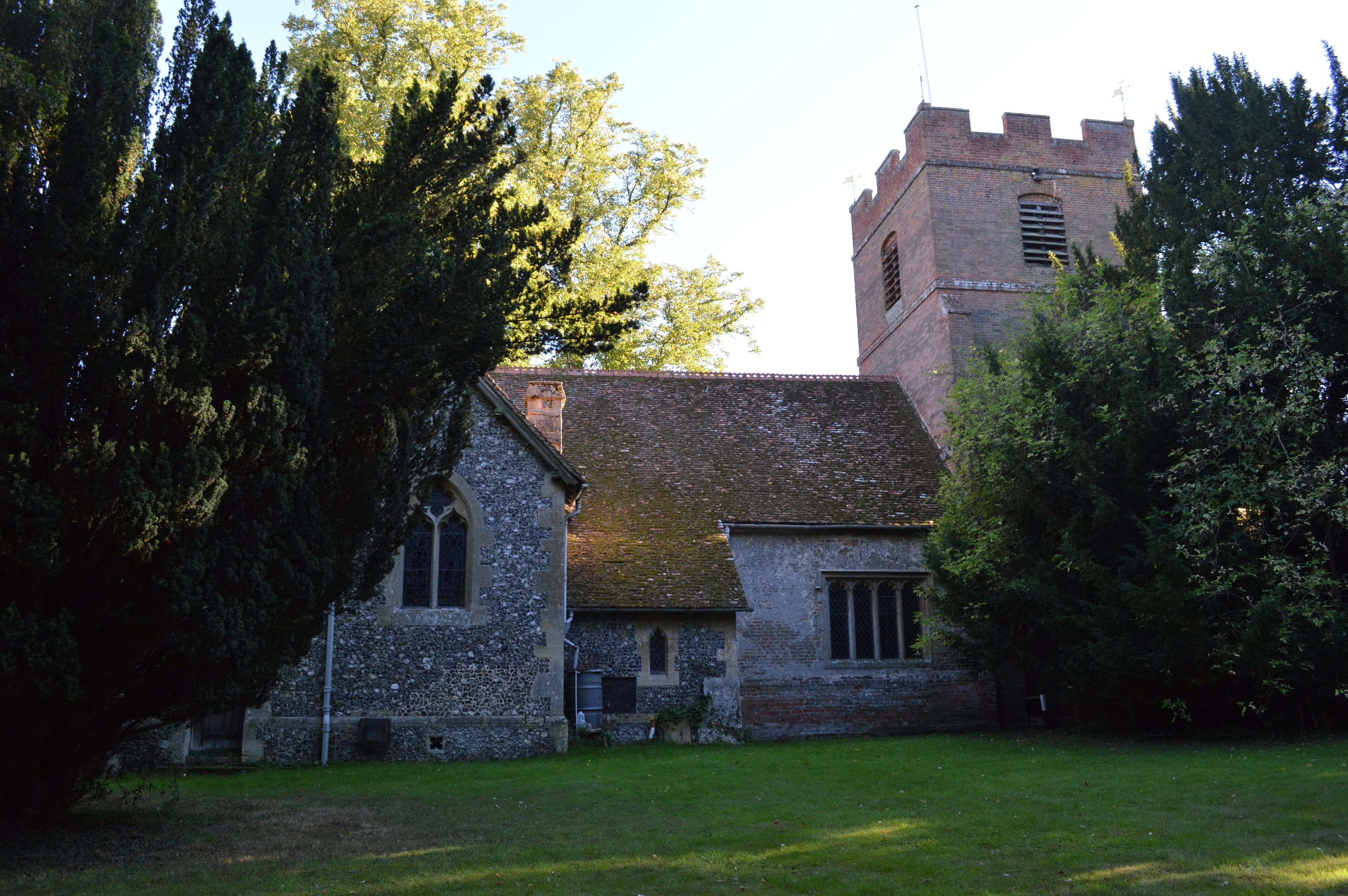 A church with a tower and a stone building.