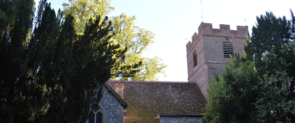 A church with a tower and a stone building.