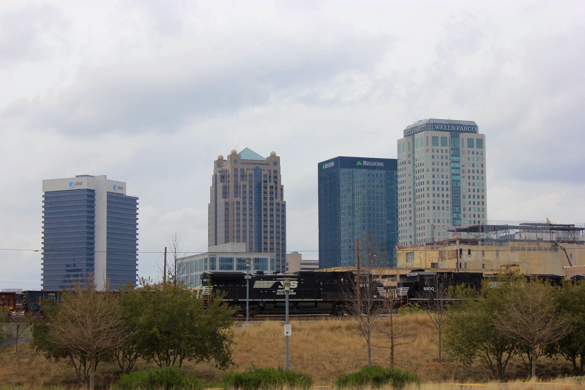 A view of downtown Birmingham with a Norfolk Southern locomotive passing by from Railroad Park.  Railroad Park is a 19-acre park in Birmingham, Alabama, that opened in the fall of 2010. The park lies immediately south of the Norfolk Southern and CSX rail lines through downtown Birmingham. It stretches from 14th Street to 18th Street along First Avenue South.