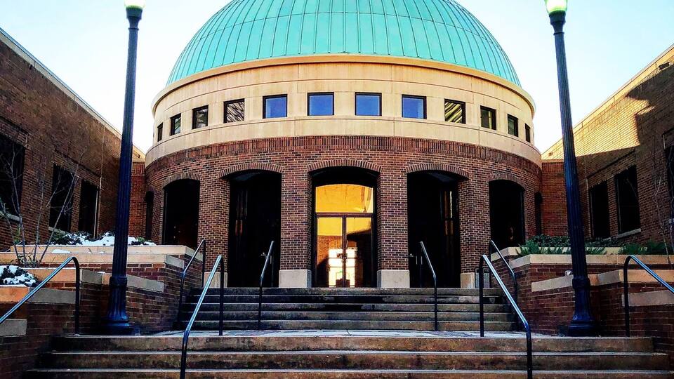 A building with a large dome and a brick facade.