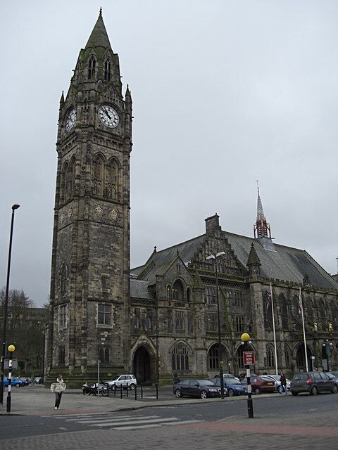 A historic building with a clock tower and another spire.