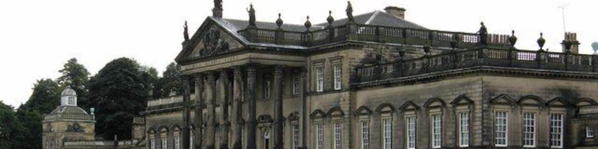 A large, historic building with a symmetrical facade, large windows, and a central entrance.