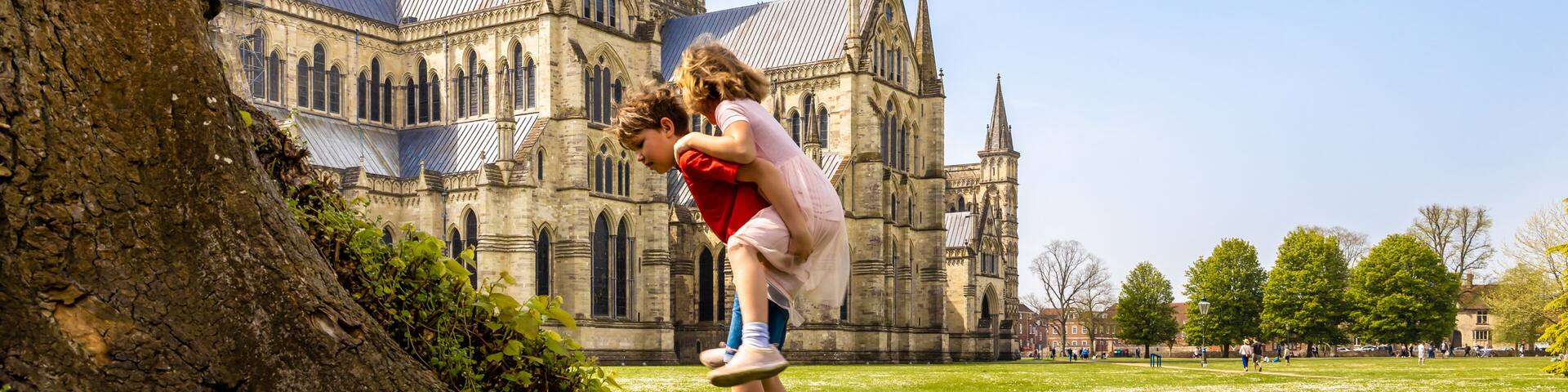 Family at Salisbury cathedral in sunny day