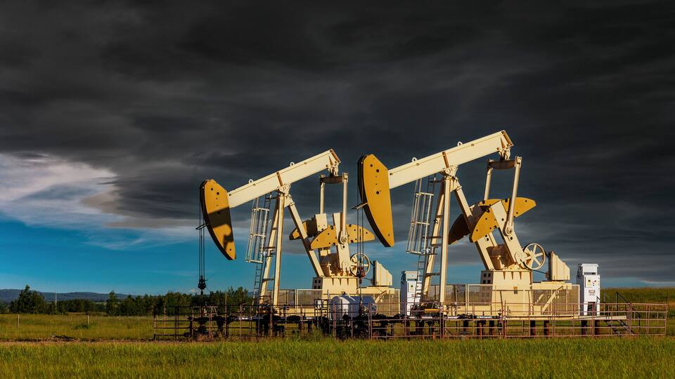 Oil pumps with a cloudy sky in the background.
