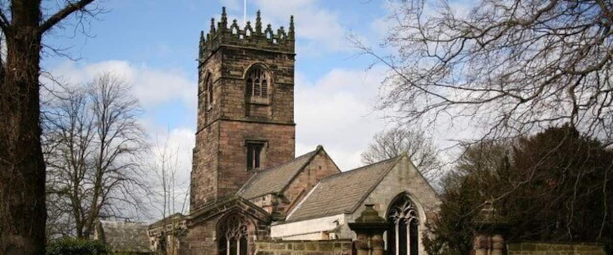 A church with a tall tower and arched windows.
