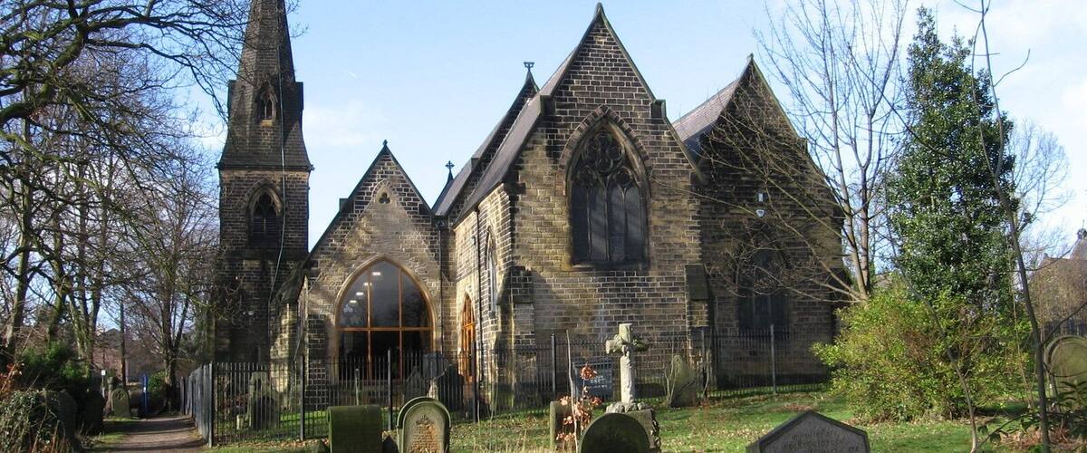 A historic church with a tall steeple and arched windows.