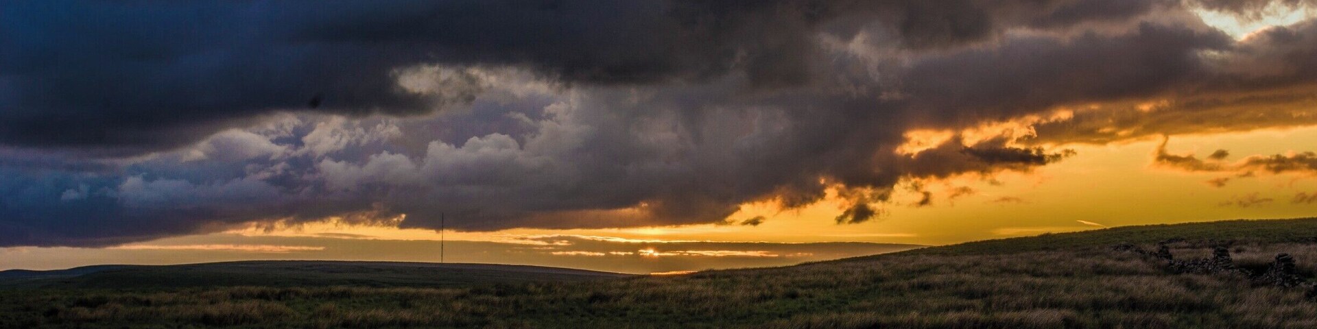 Sunset behind stormy clouds.