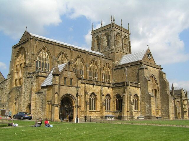 A large stone church with a prominent tower and arched windows.