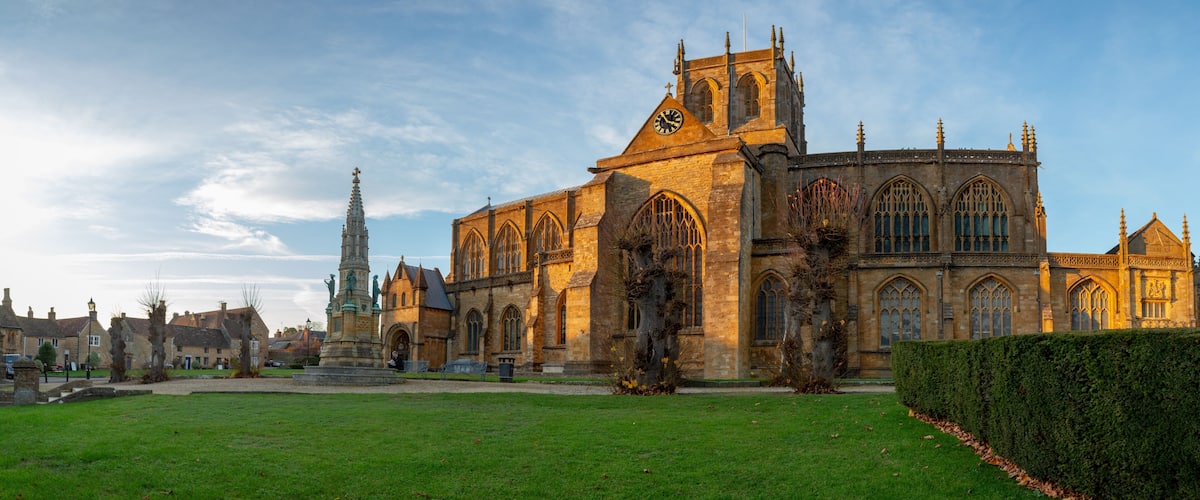 A historic cathedral with large arched windows and a tall spire.