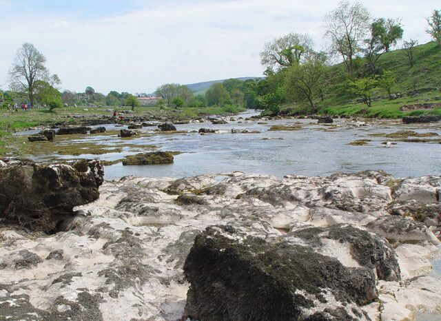 After Ghaistrill's Strid There is still plenty of limestone in and under the river, but the gradient is lower and the river is wider as it approaches Grassington and Threshfield.