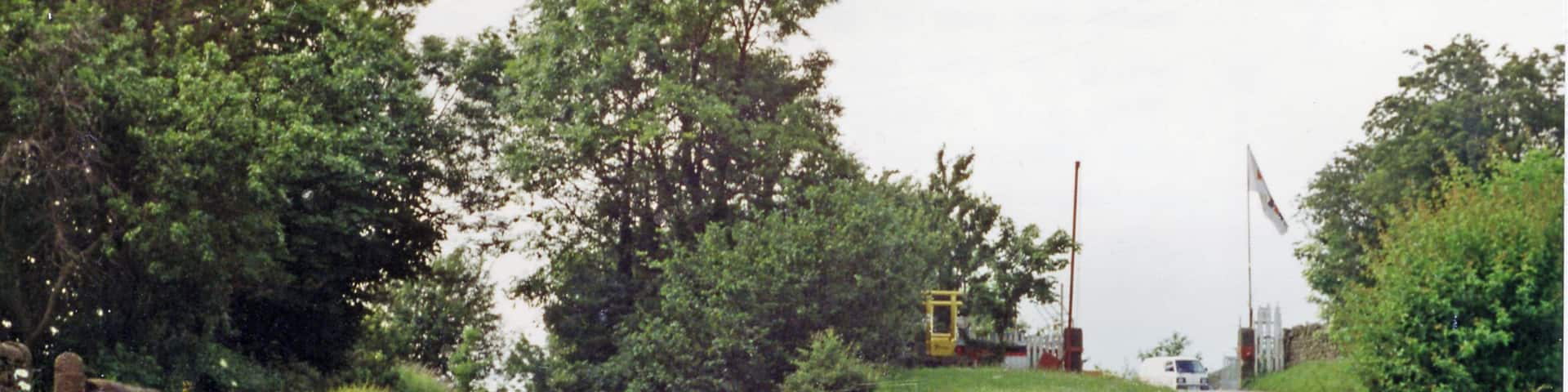 Site of former Elslack station, 1996. View NW at bridge over the course of the ex-Midland Skipton (to right) - Colne (to left) line, a useful cross-Pennine connecting line. The station had been below on the right and was closed as long ago as 3/3/52, but the line survived until 2/2/70.