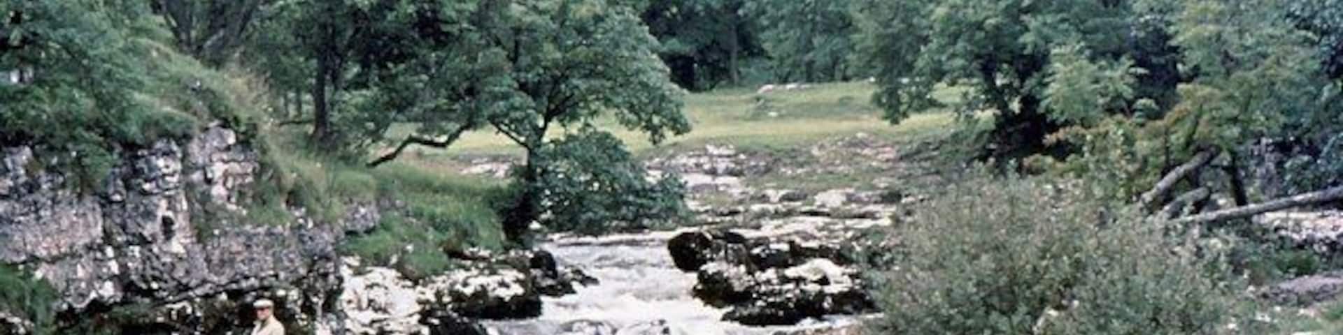The Wharfe above Grassington. A fisherman casts his line into a deep pool not far downstream from Ghaistrill's Strid.
