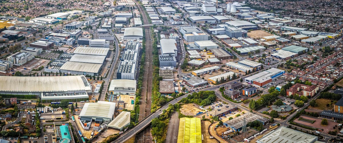 An aerial view of a densely packed industrial area with numerous warehouses, factories, and large buildings.