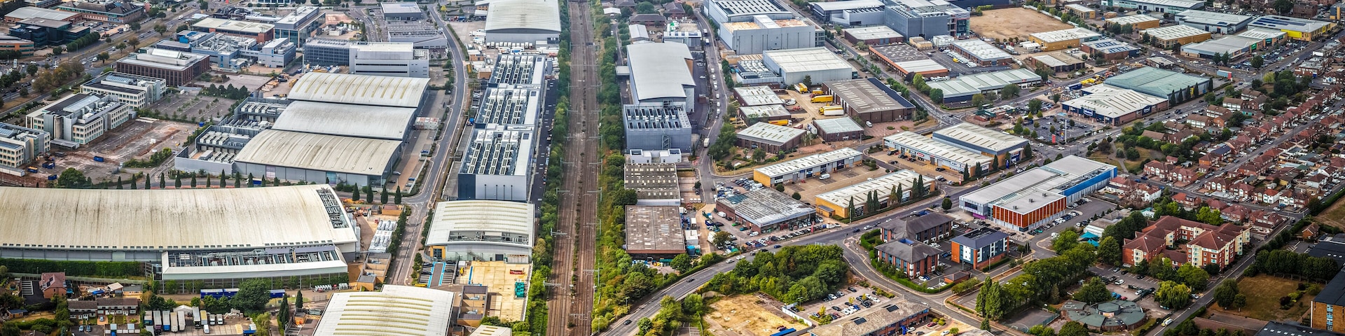 An aerial view of a densely packed industrial area with numerous warehouses, factories, and large buildings.