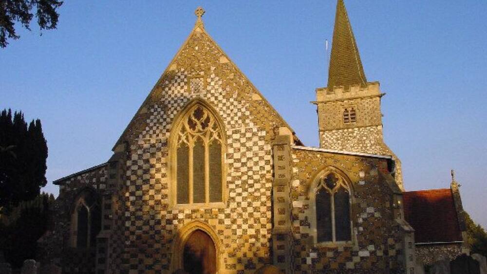 A church with a checkered facade and a tall tower.