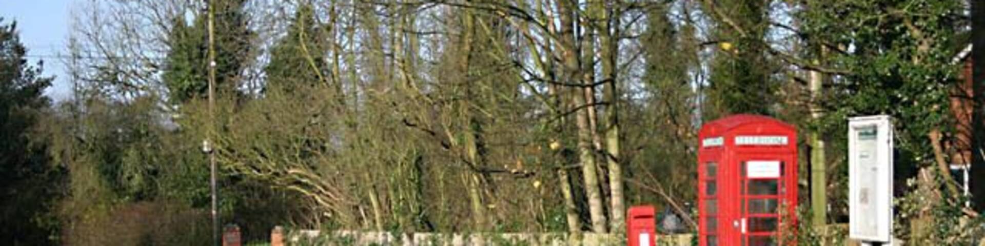 Notice board The board is to announce information from Bickenhill Parish Council. The notice on the phone box states, 'coind not accepted'.