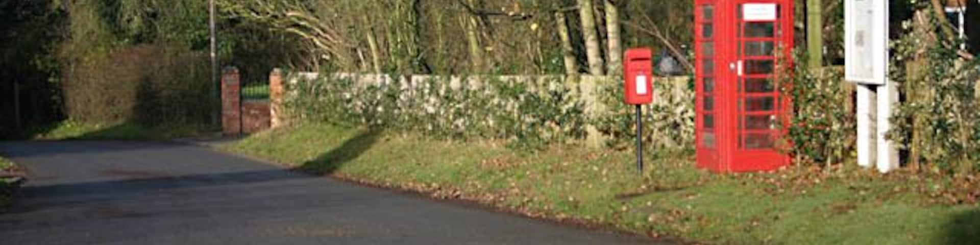 Notice board The board is to announce information from Bickenhill Parish Council. The notice on the phone box states, 'coind not accepted'.