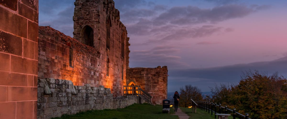 Beautiful sunset on ancient Stafford Castle with colorful sky and light on castle.