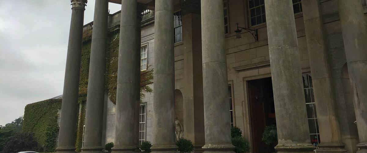 A neoclassical building with a portico supported by large columns and a triangular pediment.