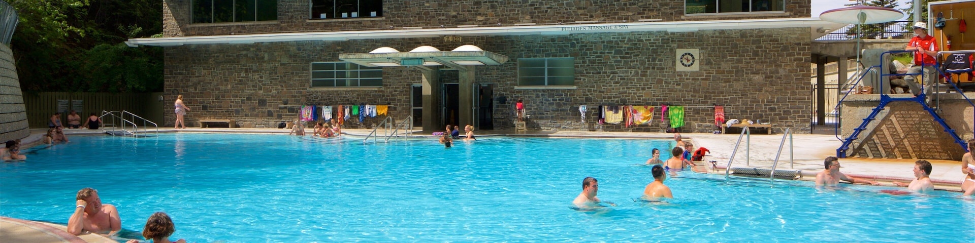 Kootenay National Park featuring a pool and swimming as well as a small group of people